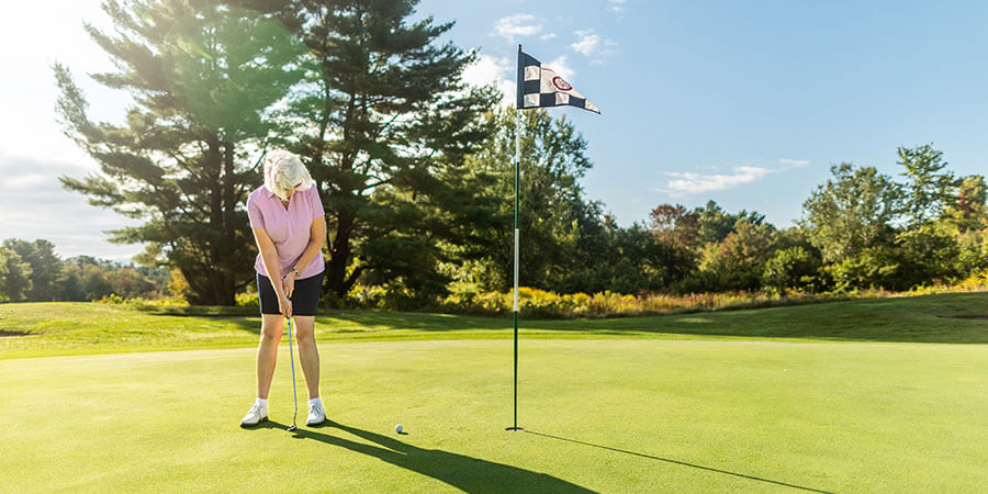 Senior woman golfing